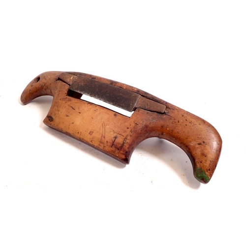 845 - An antique fruitwood convex spoke shave, 28cm wide