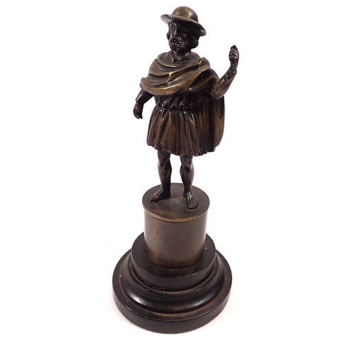 861 - A cast bronze figure of man in hat and tunic on pedestal and wooden base, 19cm tall