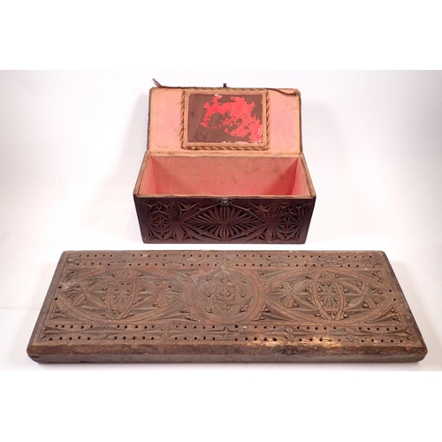 863 - A large gothic design cribbage board, 45cm long together with a gothic carved wooden box