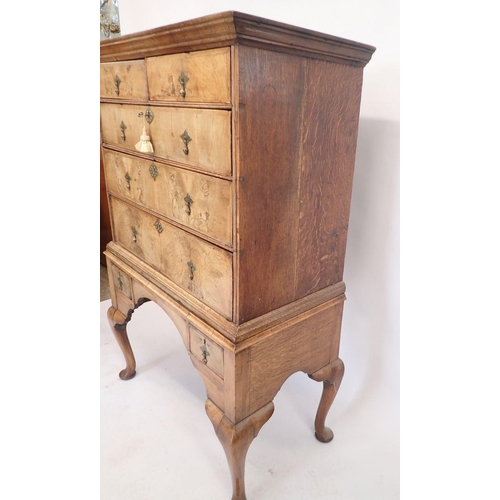 1062 - An early 18th century walnut chest on stand with two short drawers over four long all on cabriole su... 