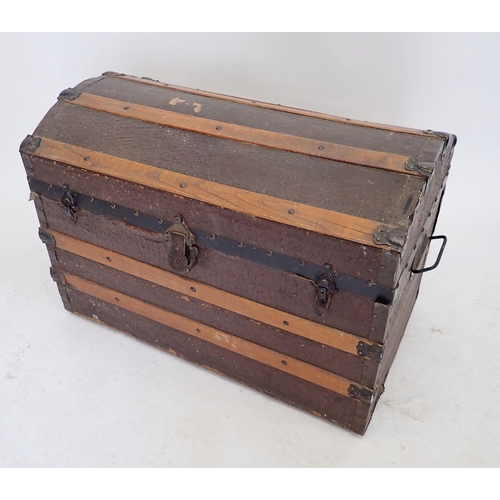 1079 - An iron and wood bound dome top trunk, 77cm wide