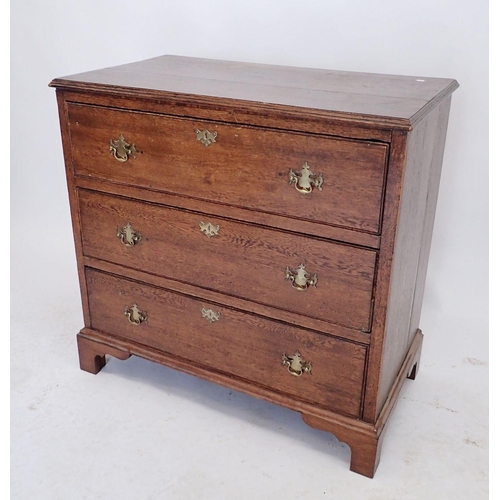 1099 - A 19th century oak Georgian style small chest of three drawers with brass handles and bracket suppor... 