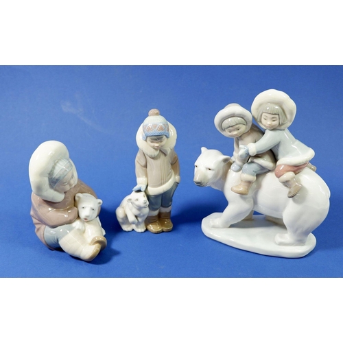 13 - Three Lladro figures, children riding a polar bear, a child with polar bear and a child petting a po... 