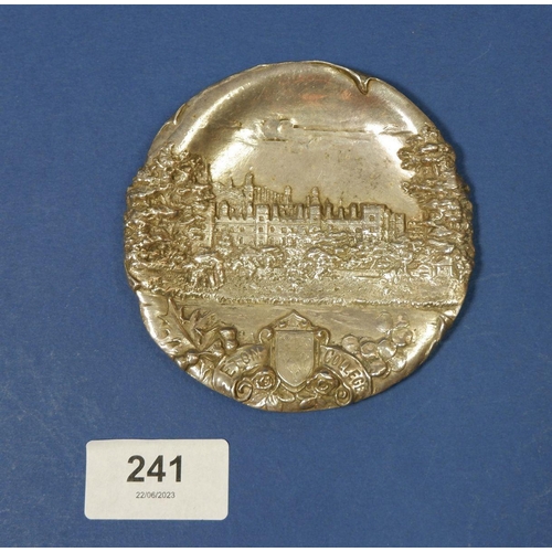 241 - A silver dish depicting Eton College on four ball feet, 9.5cm diameter, 85g