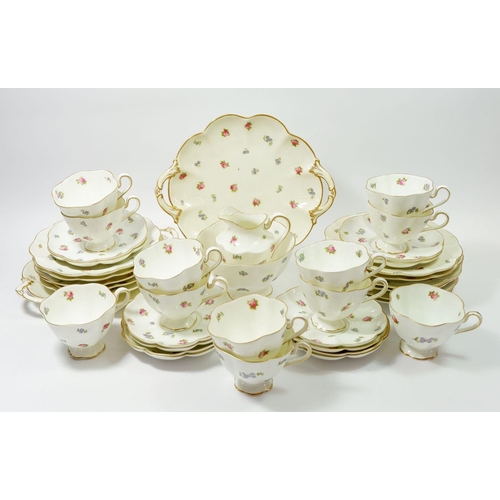 68 - A George Jones Crescent tea service with floral sprig decoration comprising twelve cups and saucers,... 