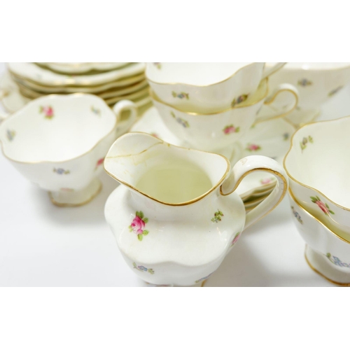 68 - A George Jones Crescent tea service with floral sprig decoration comprising twelve cups and saucers,... 