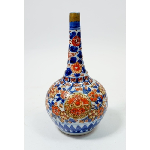 81 - A Japanese Imari bottle form vase with floral decoration, 19cm