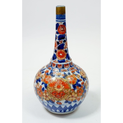 81 - A Japanese Imari bottle form vase with floral decoration, 19cm