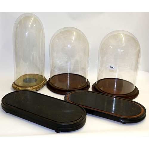 1182 - A group of three various glass domes and two dome bases, tallest 38cm