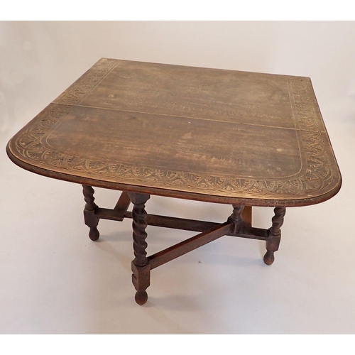 1186 - An oak drop-leaf dining table with carved border and spiral turned supports