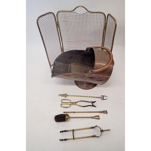 1191 - A copper helmet form coal scuttle, brass mesh firescreen, fireside set etc.