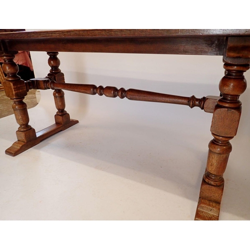 1194 - An early 20th century oak refectory style dining table on heavy turned supports, 75.5 x 183cm