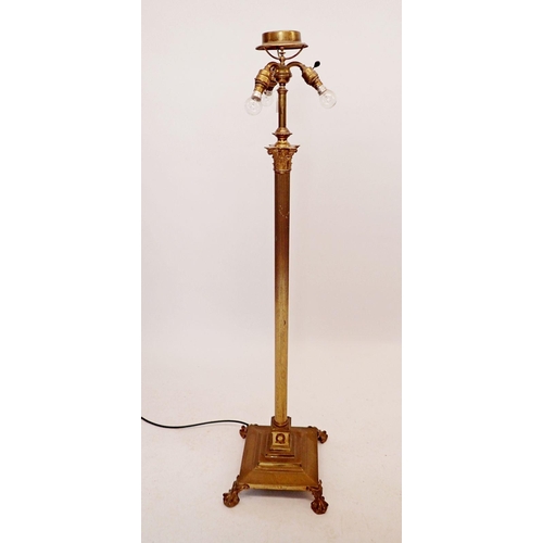 1195 - An early 20th century brass corinthian column triple light standard lamp, all on paw feet