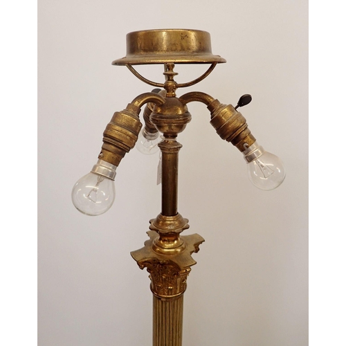 1195 - An early 20th century brass corinthian column triple light standard lamp, all on paw feet