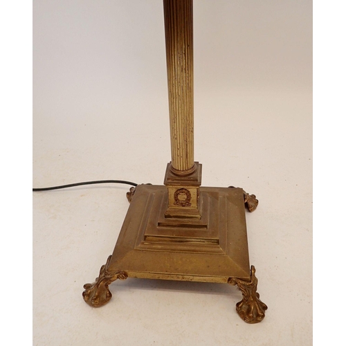 1195 - An early 20th century brass corinthian column triple light standard lamp, all on paw feet