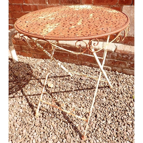 1200 - A vintage metal painted circular garden table with pierced design top with scrollwork decoration