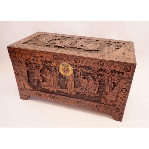 1101 - A Chinese camphorwood chest with carved decoration, 105cm wide