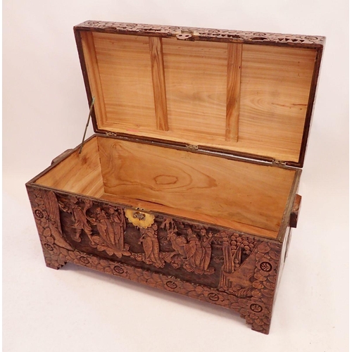 1101 - A Chinese camphorwood chest with carved decoration, 105cm wide