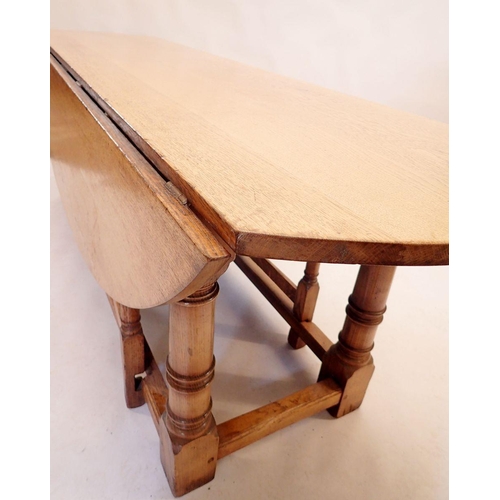 1128 - A good quality large Brynhall oak dropleaf oval dining table on turned column supports 226x145x76cm