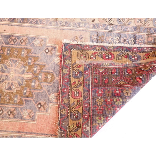 1129 - A Turkoman style rug with geometrical decoration on a blue ground 217x196cm