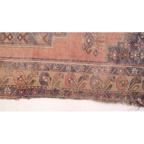 1129 - A Turkoman style rug with geometrical decoration on a blue ground 217x196cm