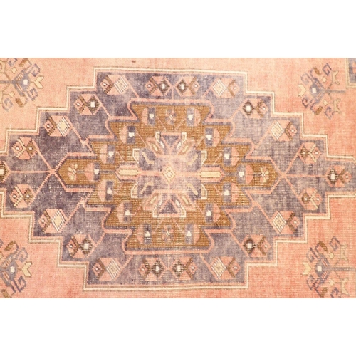 1129 - A Turkoman style rug with geometrical decoration on a blue ground 217x196cm