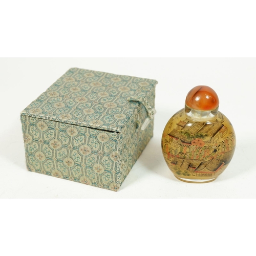 186A - A Chinese glass snuff bottle with agate lid, 8cm tall
