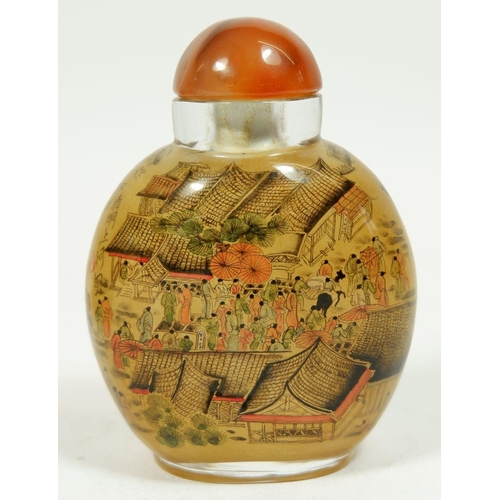 186A - A Chinese glass snuff bottle with agate lid, 8cm tall