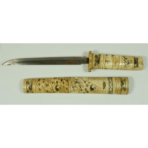 211 - A Japanese bone tanto with engraved decoration, 30cm long (lacking end piece)