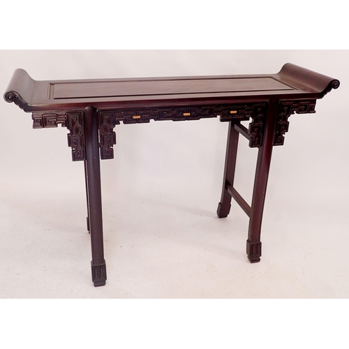 215 - A Chinese hardwood altar table with scroll over end and blind fretwork carved frieze, 125cm wide x 3... 