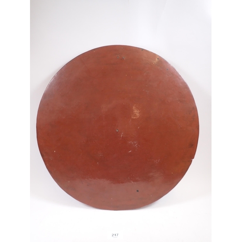 217 - An Oriental circular red lacquer papier mache panel decorated with peacock and immortals, 46cm diame... 