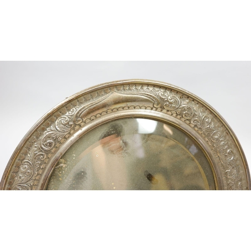 255 - A Victorian silver easel mirror with embossed scrollwork and floral decoration, 28cm diameter, Birmi... 