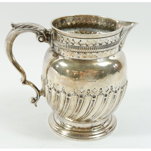 262 - A silver jug with half reeded decoration, 318g, London 1909 by C S Harris & Sons Ltd, 12.5cm