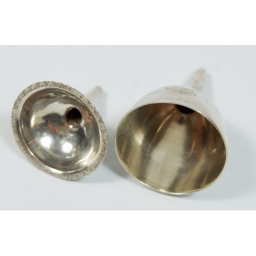 271 - Two silver plated miniature wine funnels and a white metal part eastern cruet set