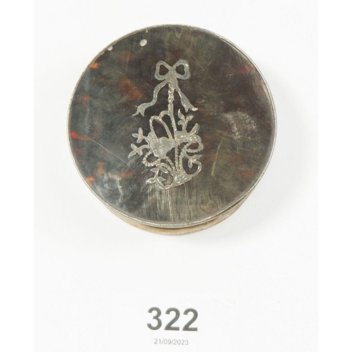 322 - A silver and tortoiseshell circular box with inlaid ribbon and floral decoration, London 1918, 6cm d... 