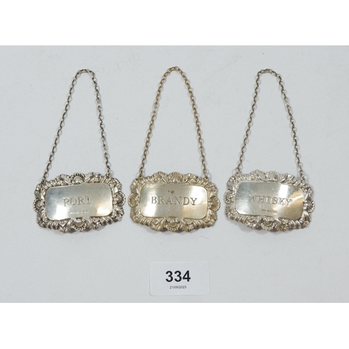 334 - Three silver decanter labels: Whisky, Brandy & Port