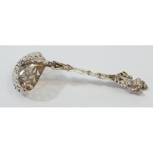 344 - A silver sifter spoon with mother and child terminal and gilt bowl, 51g