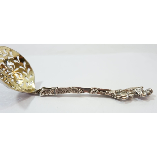 344 - A silver sifter spoon with mother and child terminal and gilt bowl, 51g