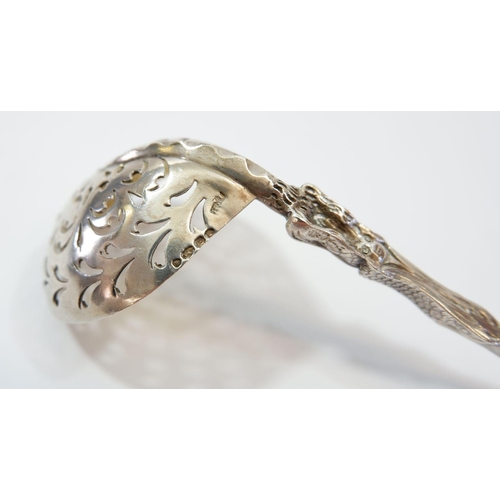 344 - A silver sifter spoon with mother and child terminal and gilt bowl, 51g