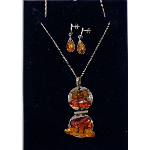 531 - A large silver and amber pendant and a pair of silver and amber earrings