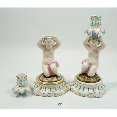 77 - A pair of Meissen style candlesticks with kneeling putti, 21cm tall