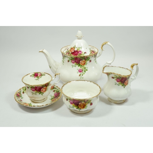 79 - A Royal Albert Country Roses tea service comprising: teapot, eleven cups, seven saucers, eight tea p... 