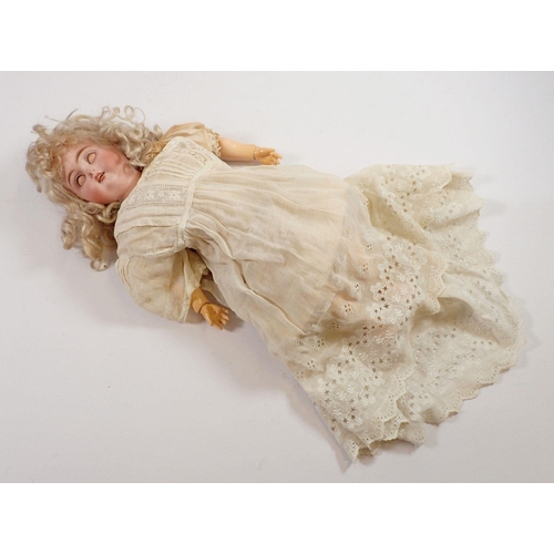 1055 - A late 19th century bisque headed doll with brown sleeping eye and open mouth, composition jointed b... 