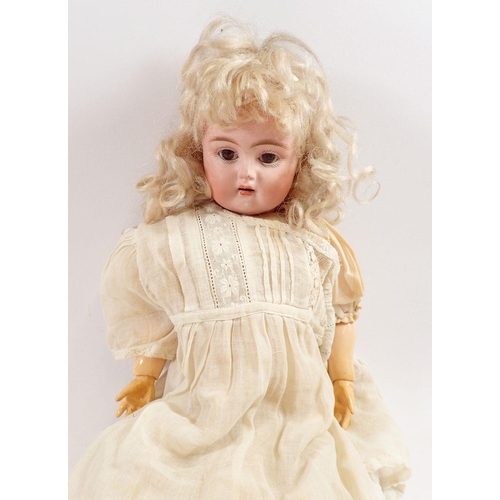 1055 - A late 19th century bisque headed doll with brown sleeping eye and open mouth, composition jointed b... 