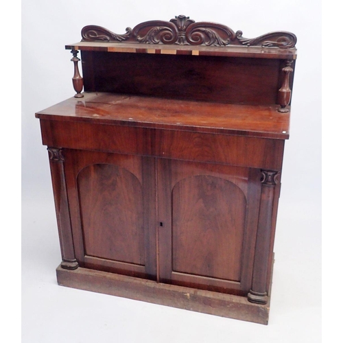 1092 - An early Victorian mahogany chiffonier with carved raised back over frieze drawer and pair of panell... 