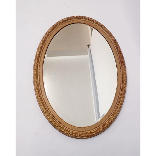 1093 - A large gilt framed oval mirror, 84 x 61cm