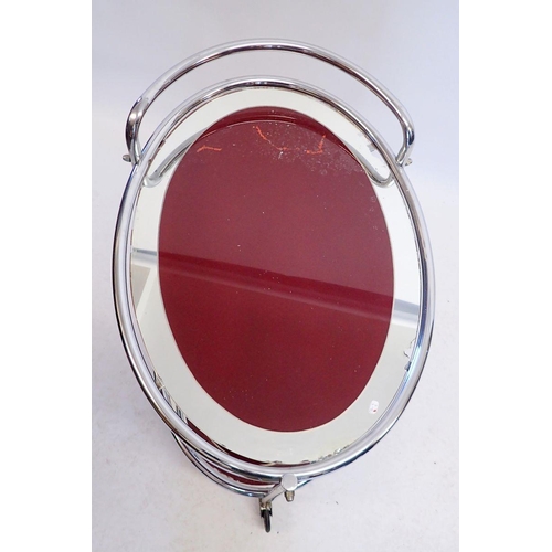 1102 - A French 1920's oval chrome and mirrored glass cocktail trolley