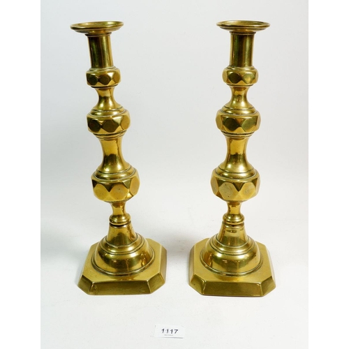 1117 - A pair of brass ecclesiastical candlesticks with pushers, 36cm