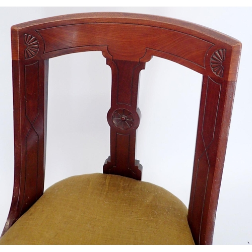 1145 - A set of four Victorian mahogany Etruscan style slope back dining chairs with incised decoration