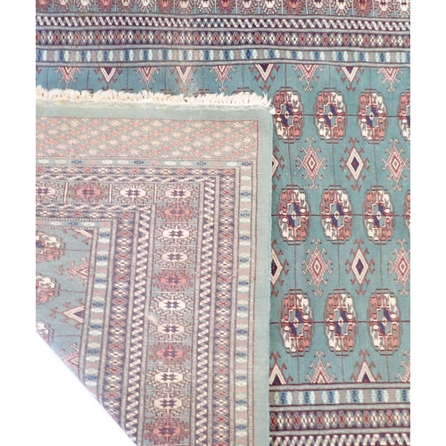 1148 - A Turkoman rug with multiple guls on a green ground 178x128cm